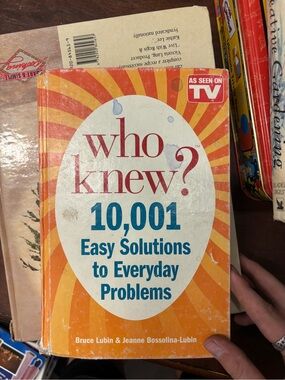Lee orange and white "Who Knew? 10,001 Easy Solutions to Everyday Problems"